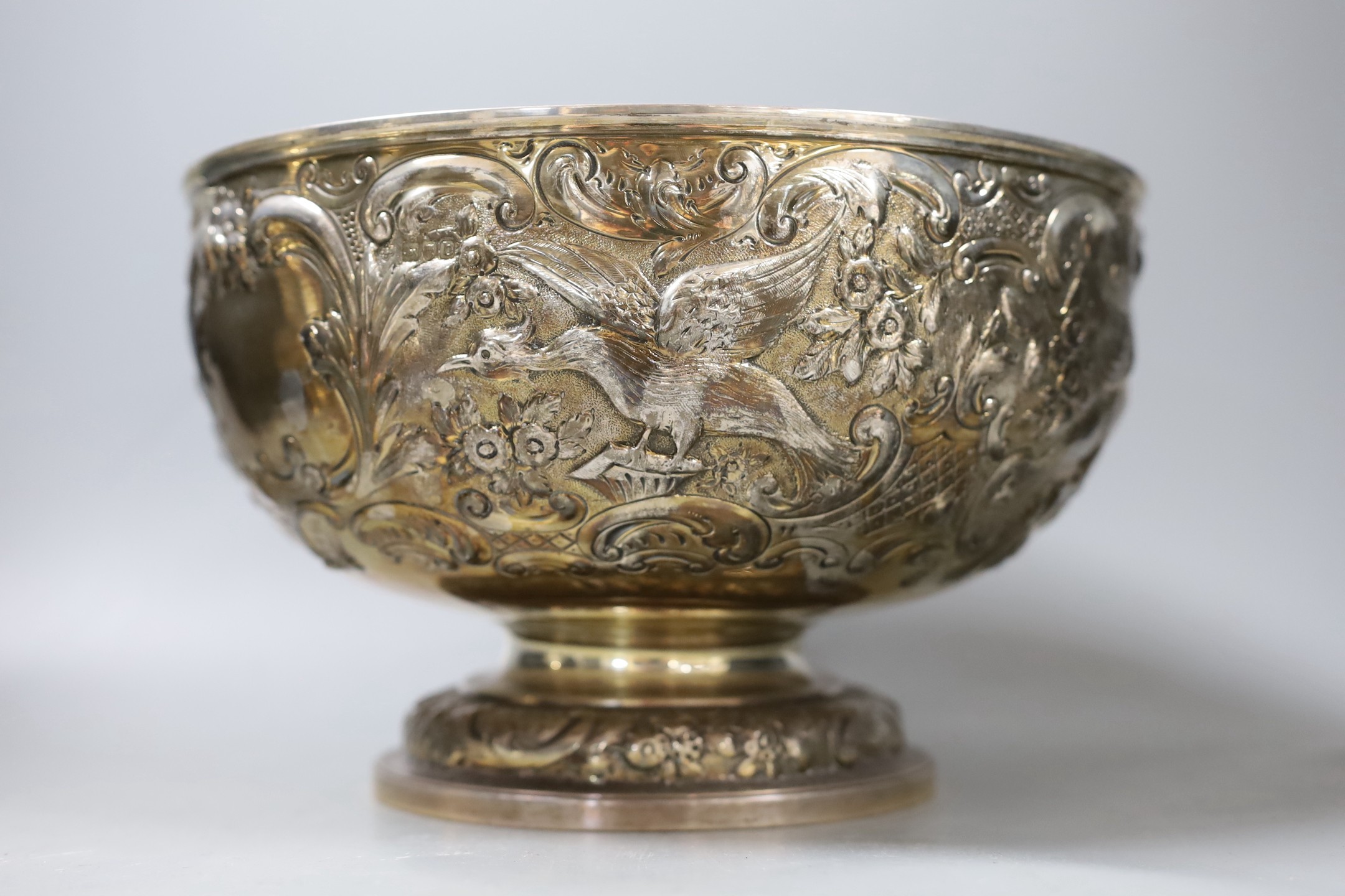 A late Victorian embossed silver rose bowl, decorated with birds amid scrolls, Carrington & Co, London, 1897, diameter, 26.5cm